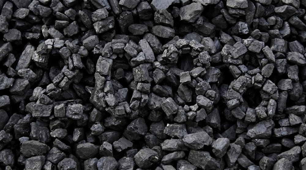 Pezzi di carbone grezzo disposti a formare il numero 2038 su uno sfondo  di carbone, a rappresentare il rinvio della chiusura delle centrali a carbone  italiane al 2038.